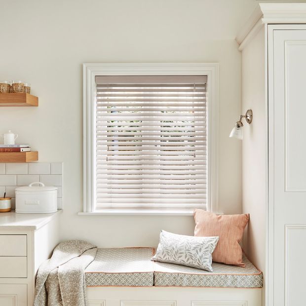Off white farmhouse kitchen with rustic accessories and white wash wood venetian blind