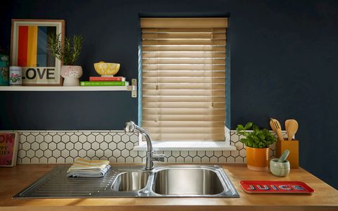 navy kitchen with colourful accessories featuring wooden venetian blind