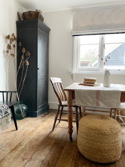 A-meal-setting-in-a-room-with-a-table-chairs-a-window-covering-by-a-neutral-patterned-Roman-blind