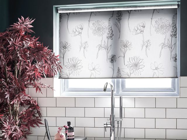 Hillarys Roller Blind in Pippa Ink covering a window in the bathroom over the top of a large white bath