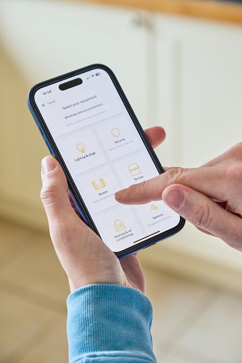 Close up of a mobile phone screen showing a garage door app and a finger poised to tap it.