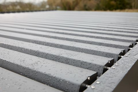Close up of grey louvred roof of a freestanding pergola.