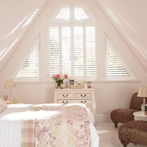 White shaped shutters in a roof conversion window