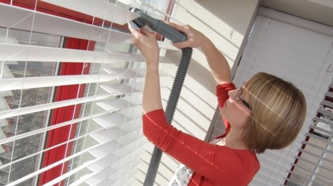 Clean wooden blinds with a vacuum cleaner