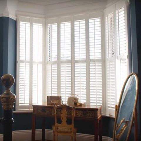 Haywood Purity Shutters in a Living Room Bay Window