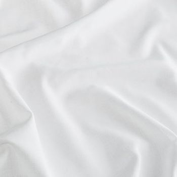 White coloured fabric swirled on a surface